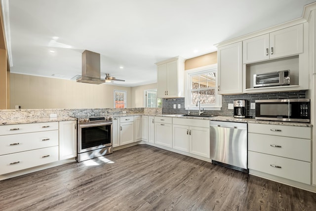 115 Clubhouse Rd, Summerville, SC 29483 - kitchen featuring a sink, a wealth of natural light, island exhaust hood, backsplash, and stainless steel appliances