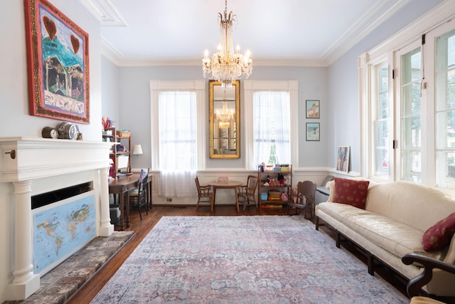 living area with dark hardwood / wood-style flooring, crown molding, and a chandelier