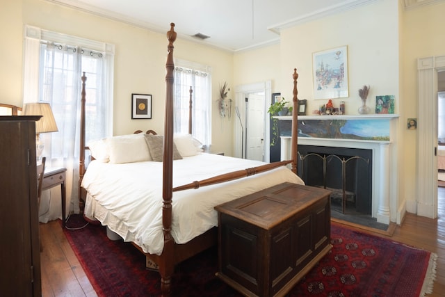 bedroom featuring dark hardwood / wood-style floors and ornamental molding