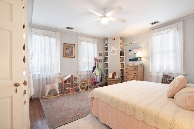 bedroom with multiple windows, ceiling fan, crown molding, and wood-type flooring