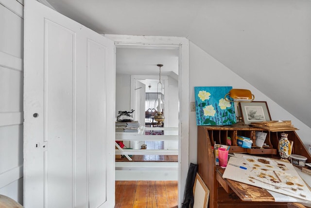 interior space featuring hardwood / wood-style floors and vaulted ceiling