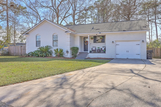 single story home with fence, concrete driveway, a front yard, a garage, and brick siding