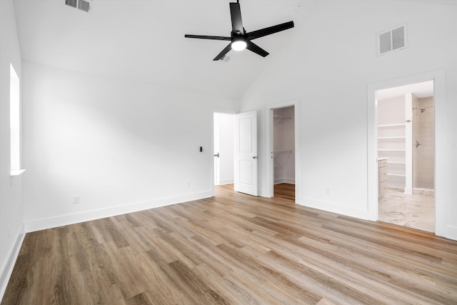 1076 Williams Rd, Charleston, SC 29412 - unfurnished bedroom featuring high vaulted ceiling, a walk in closet, light wood finished floors, baseboards, and a closet
