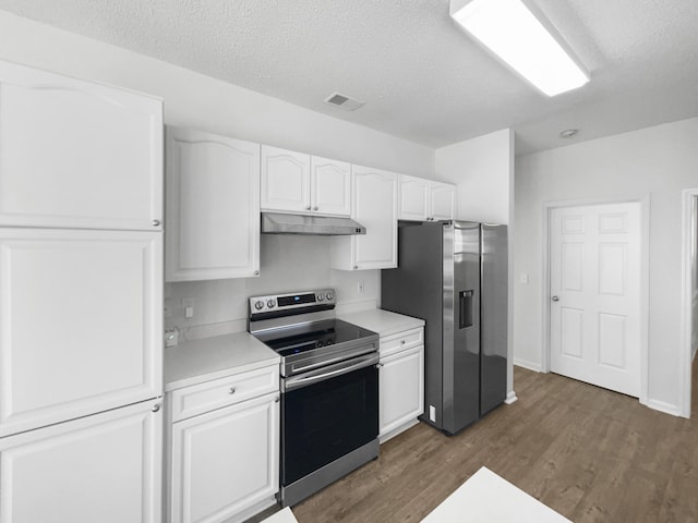 kitchen with white cabinets, under cabinet range hood, stainless steel appliances, and light countertops