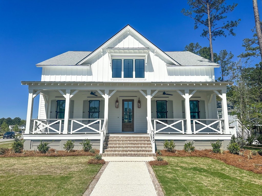 modern farmhouse style home with a porch and a front lawn