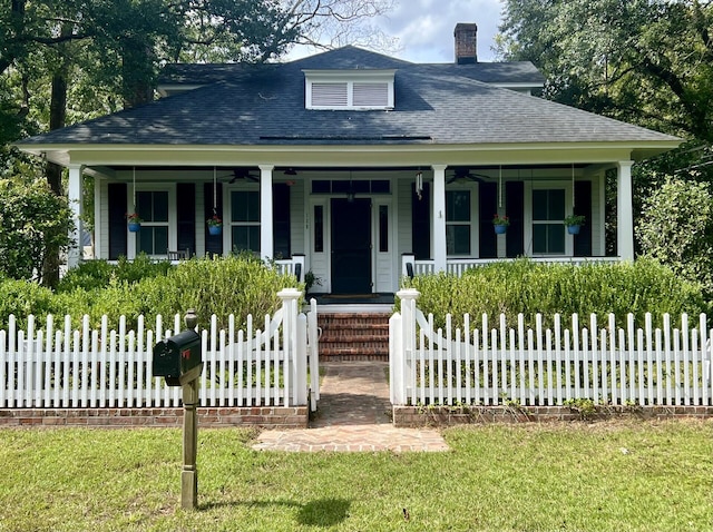 bungalow-style house featuring covered porch and a front yard