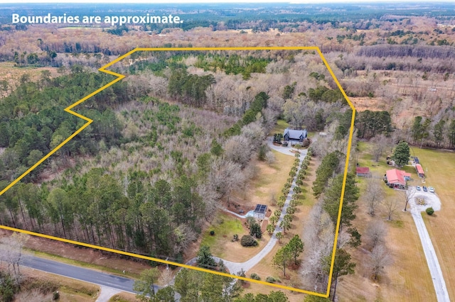 birds eye view of property with a rural view and a wooded view