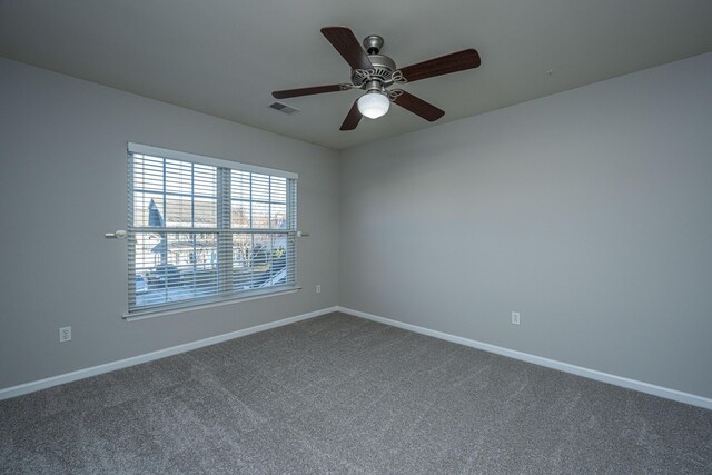 unfurnished living room with carpet flooring, built in shelves, and ceiling fan