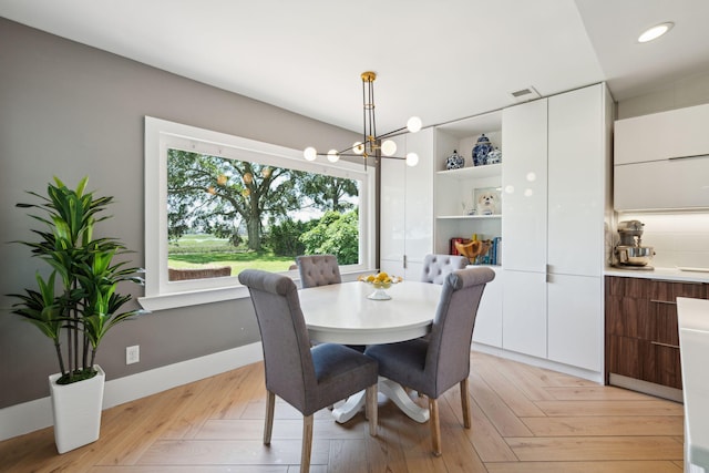 dining room featuring a chandelier, light wood finished floors, and recessed lighting