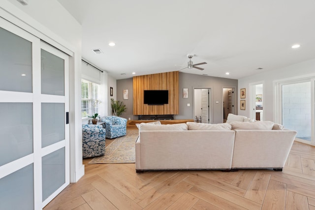 living area with a ceiling fan, lofted ceiling, and recessed lighting