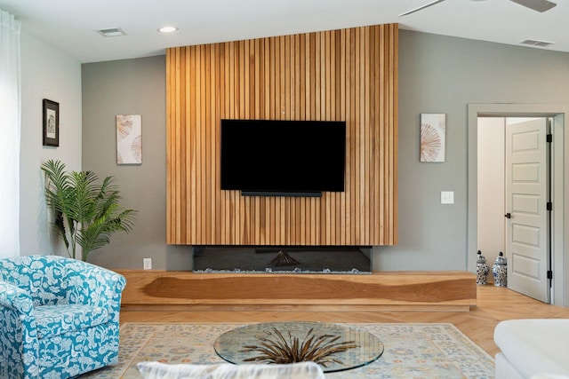 living area featuring lofted ceiling, recessed lighting, and a ceiling fan