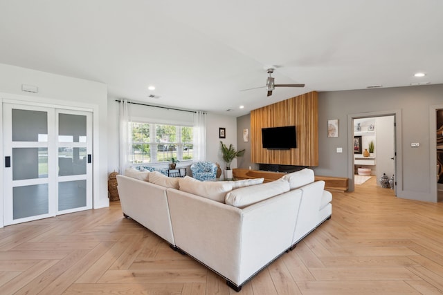 living area with a ceiling fan and recessed lighting