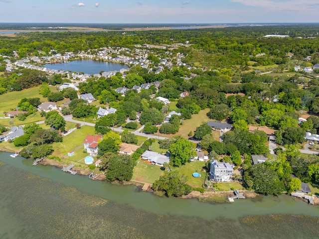 aerial view of property's location featuring a large body of water and a heavily wooded area