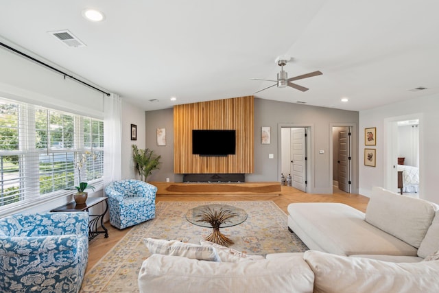 living room with ceiling fan, lofted ceiling, wood finished floors, and recessed lighting