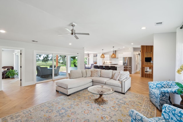 living area with recessed lighting, a ceiling fan, and baseboards