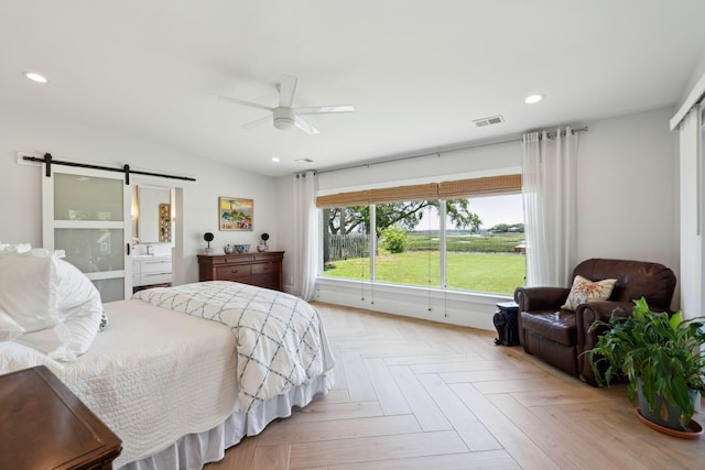 bedroom featuring a barn door, recessed lighting, and ceiling fan