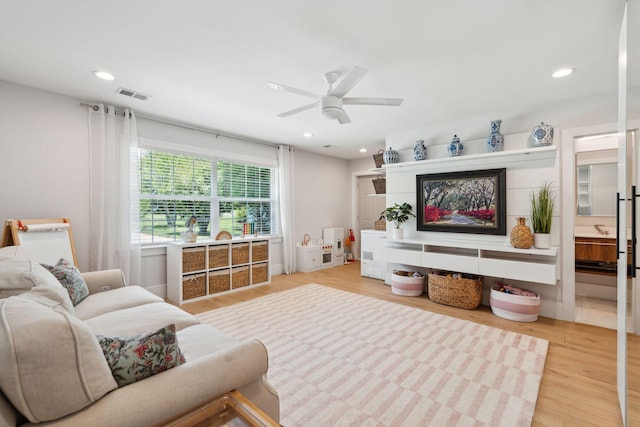 living room with ceiling fan, light wood-type flooring, and recessed lighting
