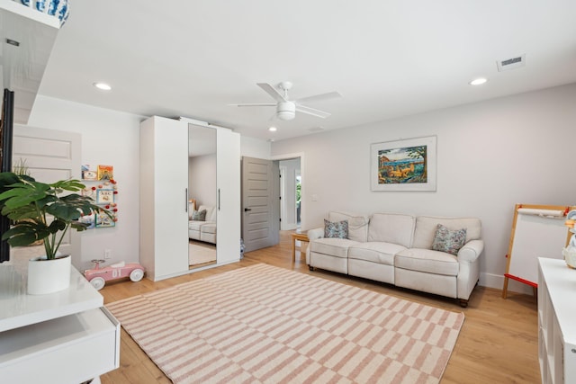 living room featuring ceiling fan, recessed lighting, light wood finished floors, and baseboards