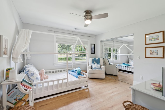 bedroom featuring light wood-type flooring and a ceiling fan