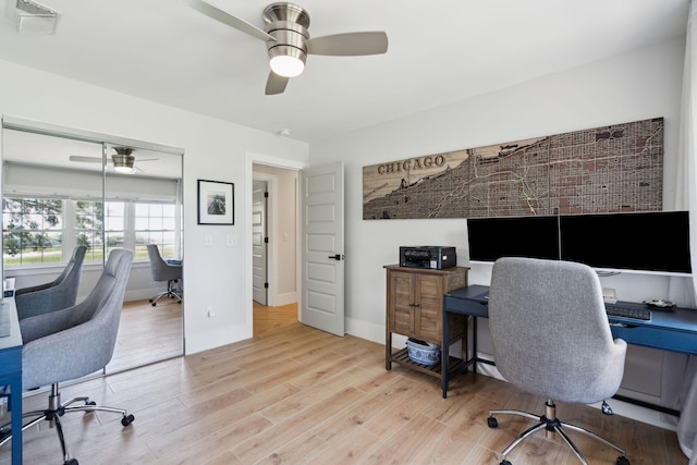 home office with a ceiling fan, wood finished floors, and baseboards