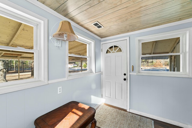 doorway with ornamental molding, wood ceiling, visible vents, and a healthy amount of sunlight