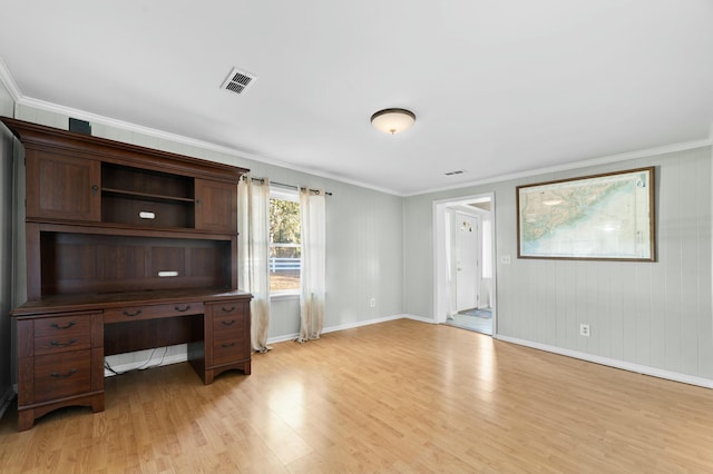 unfurnished office with light wood-type flooring, visible vents, and ornamental molding