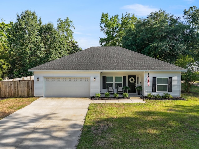 view of front of home featuring an attached garage, driveway, covered porch, and roof with shingles