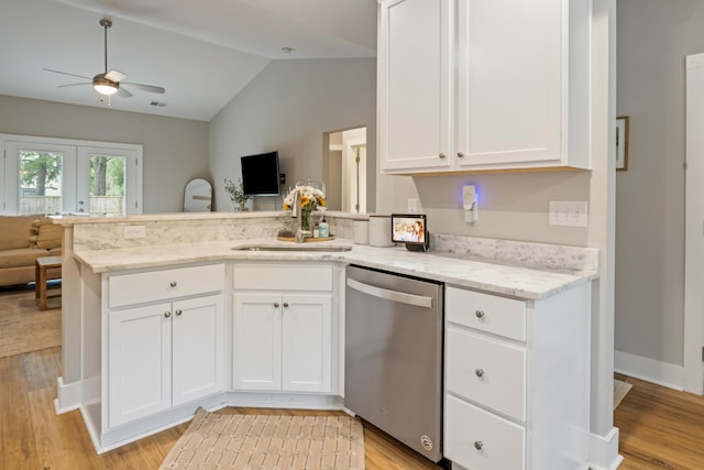 kitchen with stainless steel dishwasher, open floor plan, ceiling fan, a peninsula, and vaulted ceiling