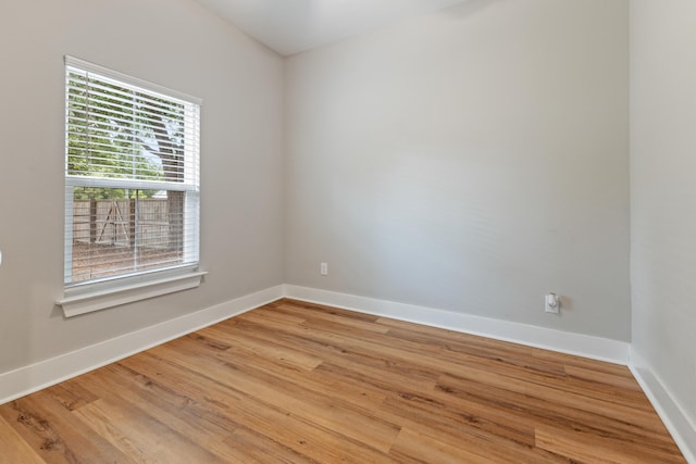 spare room with light wood-type flooring and baseboards