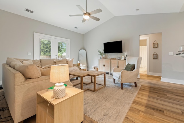 living room with ceiling fan, light wood-style floors, vaulted ceiling, french doors, and baseboards