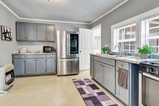 kitchen featuring ornamental molding, appliances with stainless steel finishes, gray cabinets, and sink