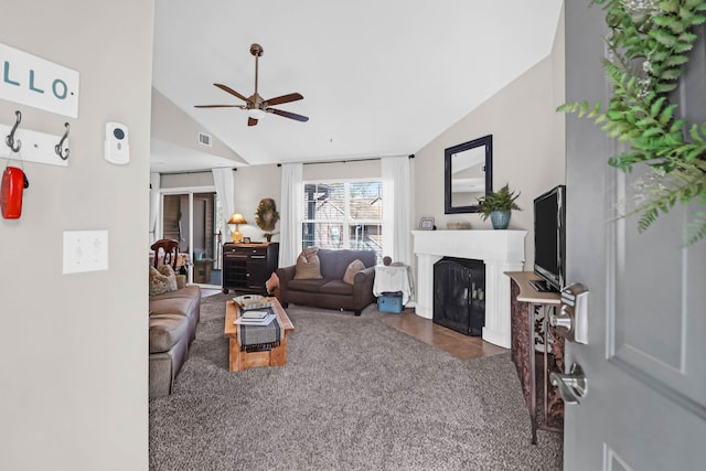 living room featuring ceiling fan and vaulted ceiling