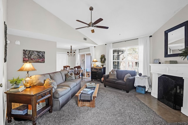 living room featuring ceiling fan with notable chandelier and vaulted ceiling