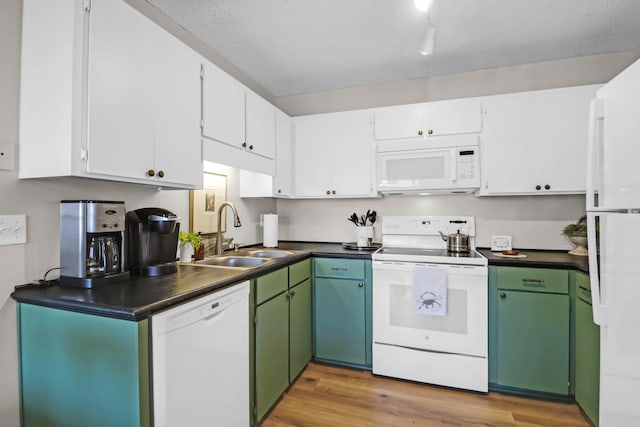 kitchen featuring sink, white appliances, white cabinetry, green cabinetry, and light wood-type flooring