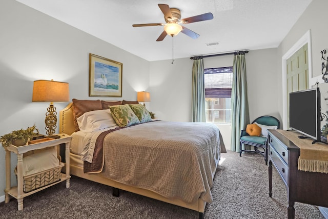 bedroom featuring ceiling fan and dark carpet