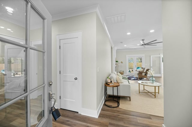 entrance foyer featuring baseboards, visible vents, wood finished floors, crown molding, and french doors