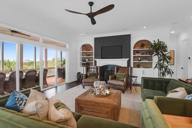 2128 Breezy Point Dr, Mount Pleasant, SC 29466 - living room with a ceiling fan, ornamental molding, a glass covered fireplace, wood finished floors, and built in shelves