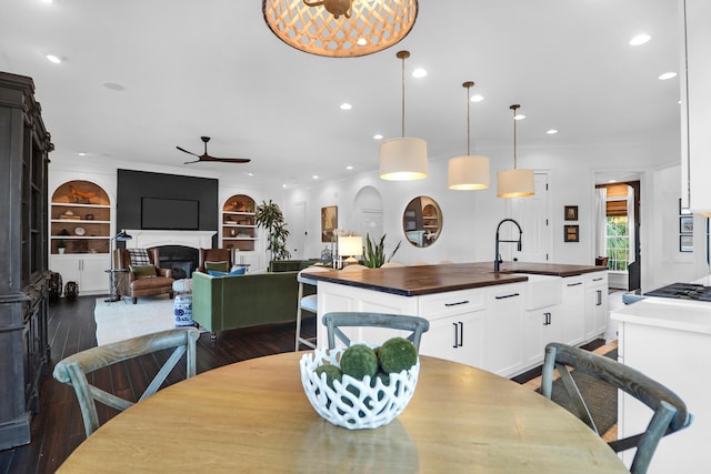 2128 Breezy Point Dr, Mount Pleasant, SC 29466 - dining area with ceiling fan, a fireplace, dark wood-style flooring, built in features, and recessed lighting