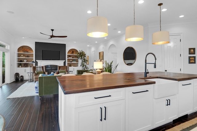 2128 Breezy Point Dr, Mount Pleasant, SC 29466 - kitchen featuring butcher block counters, a sink, ceiling fan, crown molding, and dark wood-style floors