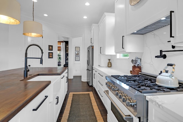 2128 Breezy Point Dr, Mount Pleasant, SC 29466 - kitchen featuring stainless steel appliances, recessed lighting, dark wood-style flooring, butcher block countertops, and white cabinetry
