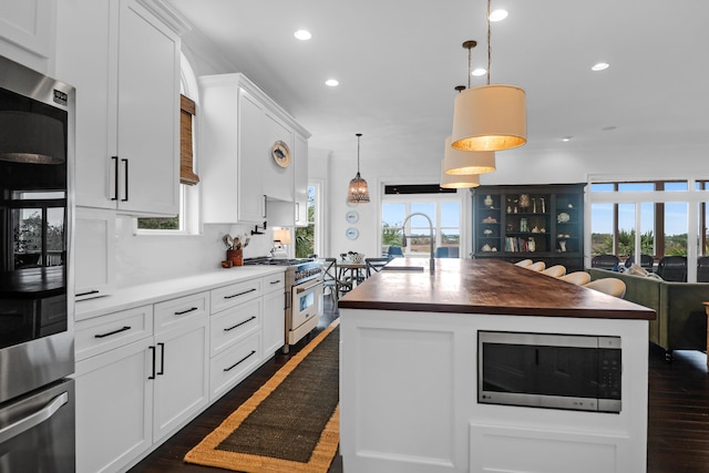 2128 Breezy Point Dr, Mount Pleasant, SC 29466 - kitchen featuring stainless steel appliances, recessed lighting, dark wood finished floors, open floor plan, and white cabinetry