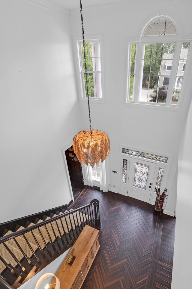 2128 Breezy Point Dr, Mount Pleasant, SC 29466 - entrance foyer with a chandelier, a towering ceiling, ornamental molding, and baseboards