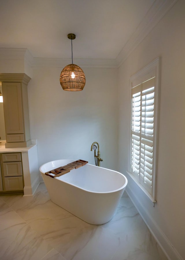 2128 Breezy Point Dr, Mount Pleasant, SC 29466 - bathroom featuring marble finish floors, a freestanding tub, baseboards, vanity, and crown molding