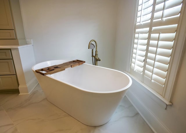 2128 Breezy Point Dr, Mount Pleasant, SC 29466 - full bath featuring marble finish flooring, a freestanding tub, and baseboards