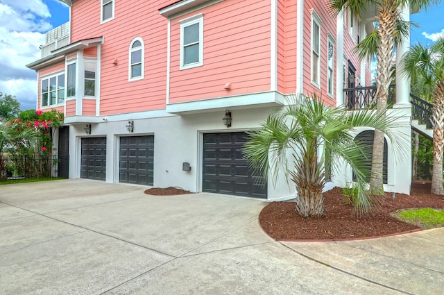 2128 Breezy Point Dr, Mount Pleasant, SC 29466 - view of side of home with an attached garage, driveway, and stucco siding
