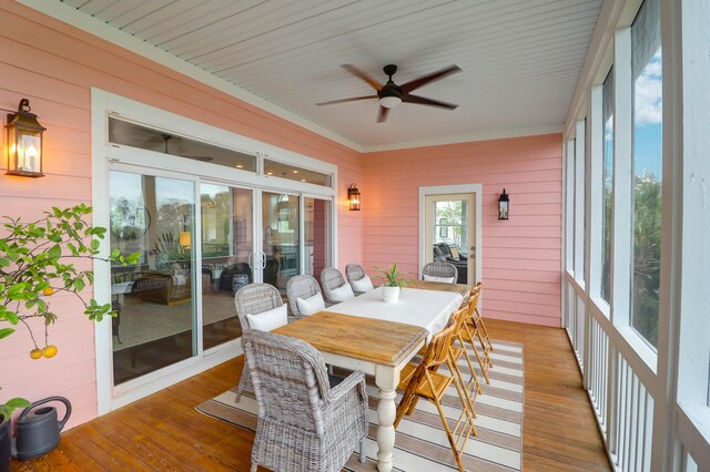 2128 Breezy Point Dr, Mount Pleasant, SC 29466 - sunroom / solarium featuring a ceiling fan, wooden walls, wood finished floors, outdoor dining area, and crown molding