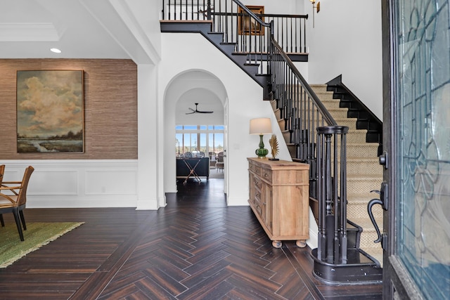 2128 Breezy Point Dr, Mount Pleasant, SC 29466 - entryway featuring stairs, recessed lighting, a ceiling fan, wainscoting, and arched walkways
