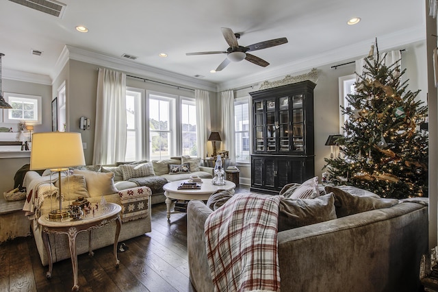 living room with ornamental molding, dark wood-type flooring, and ceiling fan