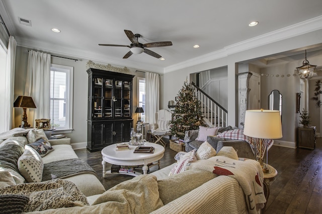 living room with ornamental molding, dark hardwood / wood-style floors, and ceiling fan