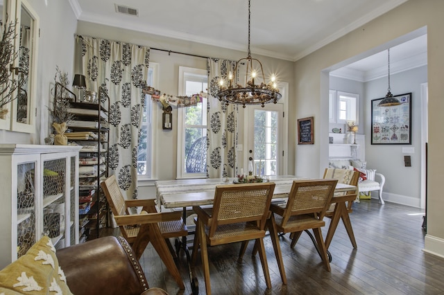 dining area with crown molding, a notable chandelier, and dark hardwood / wood-style flooring